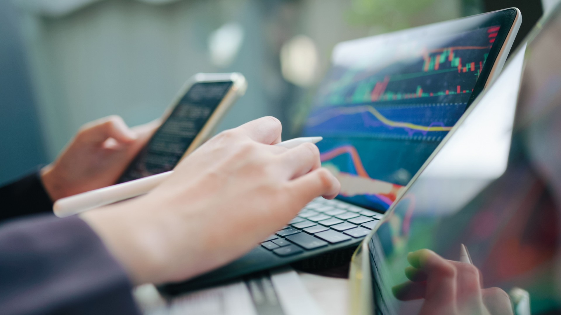 collaborative financial planning hands of female advisors working with digital tablets and physical documents for comprehensive analysis  leveraging technology and paperwork for detailed financial assessment